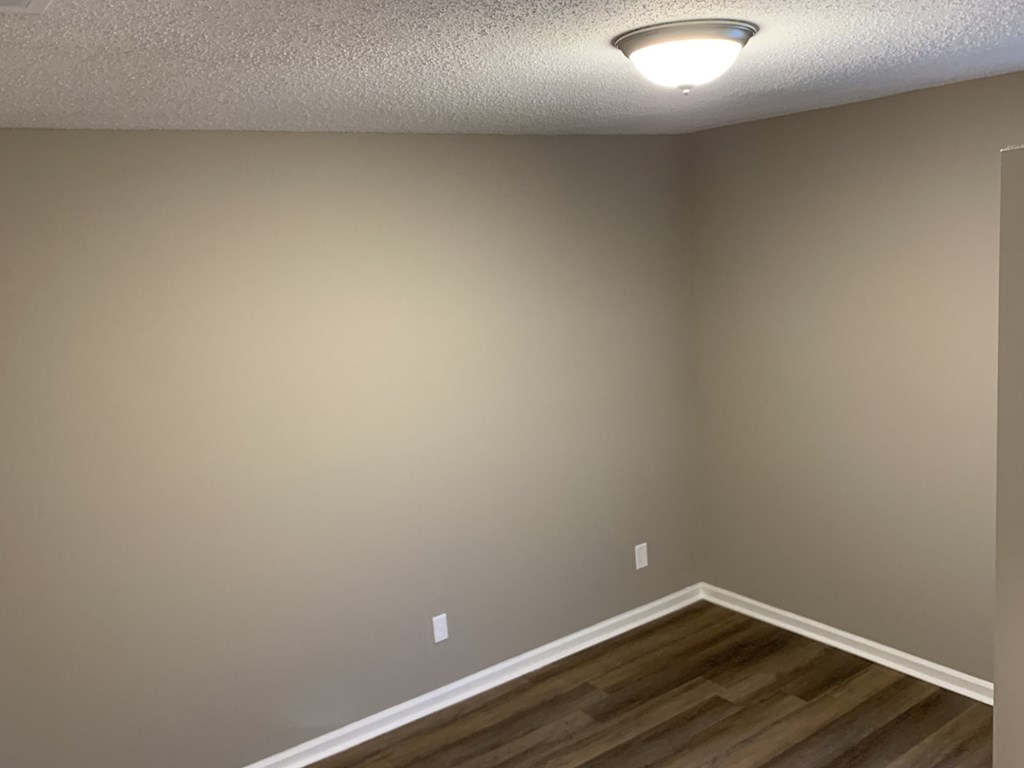 a room with a wooden floor and a light on the ceiling