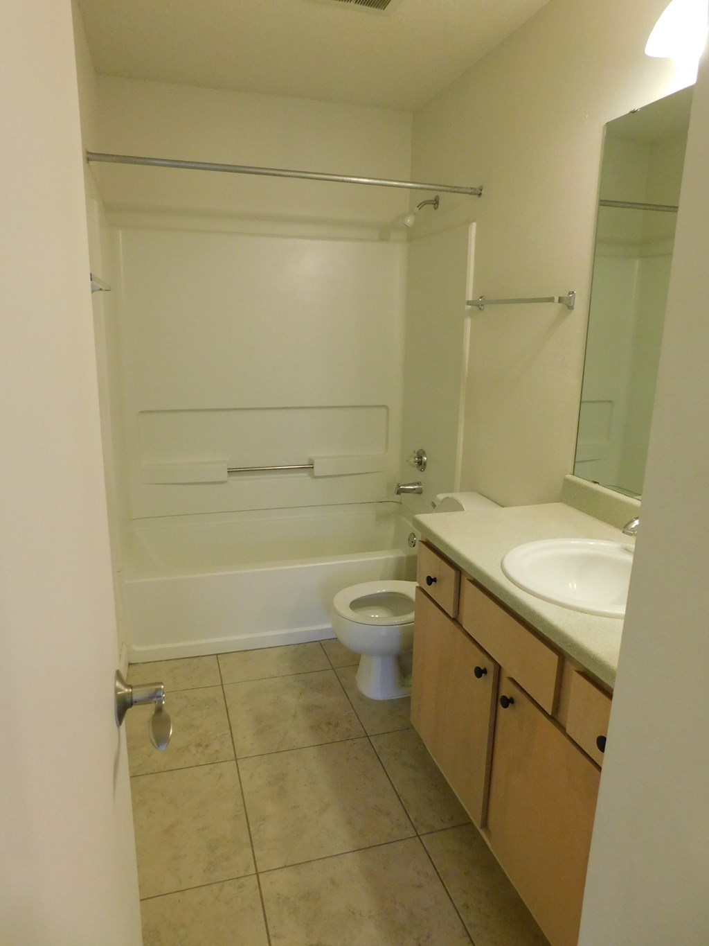 A bathroom with a toilet, sink, and shower.