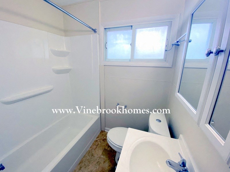 a bathroom with a toilet and a sink and a bath tub