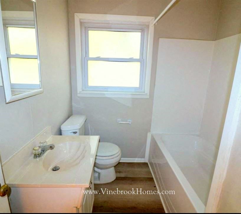 a bathroom with a toilet and a sink and a bath tub