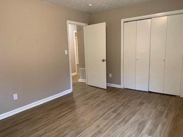 a living room with a wood floor and a closet