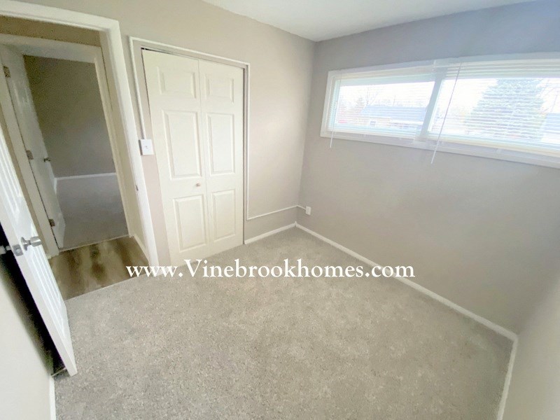 a small room with a white door and a window