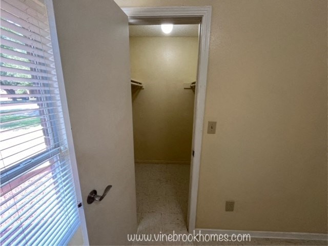 a hallway with a door to a closet and a window