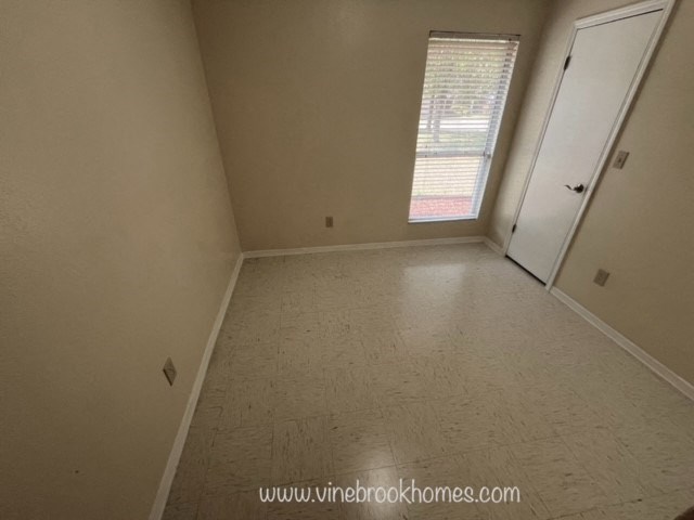 an empty room with a door and a window