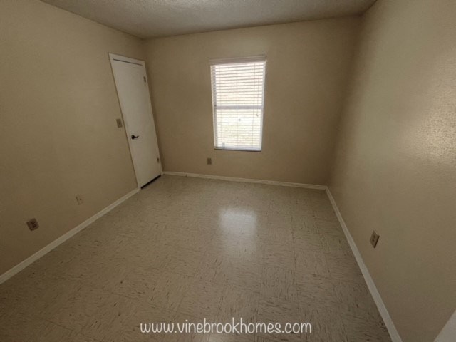 a empty room with a door and a window