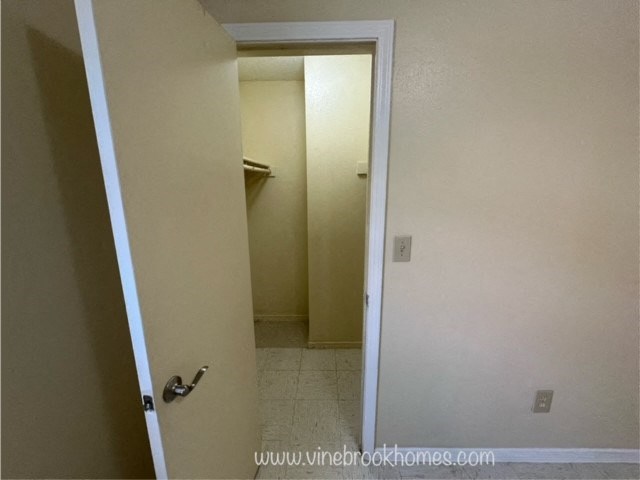 an open door to a bathroom with a closet