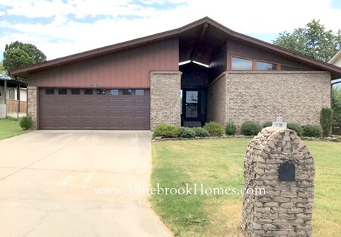 a house with a driveway and a garage door