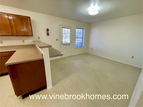 A kitchen with a counter and cabinets is shown in this image.