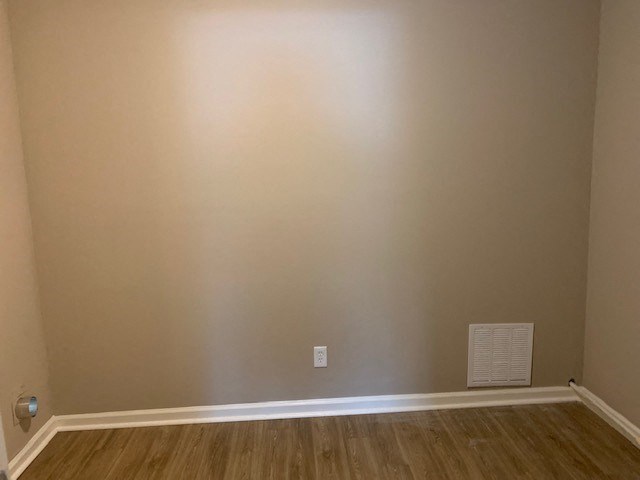 an empty room with a wall and a radiator
