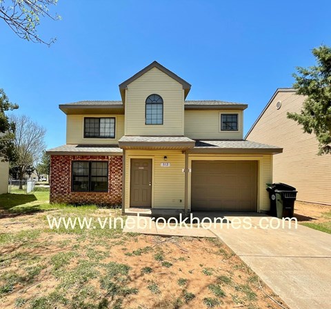 A two-story house with a garage is for sale.