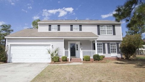 a white house with a white garage door