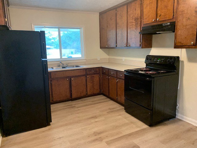 a kitchen with black appliances and wooden cabinets