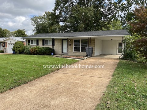 A house with a driveway in front of it.