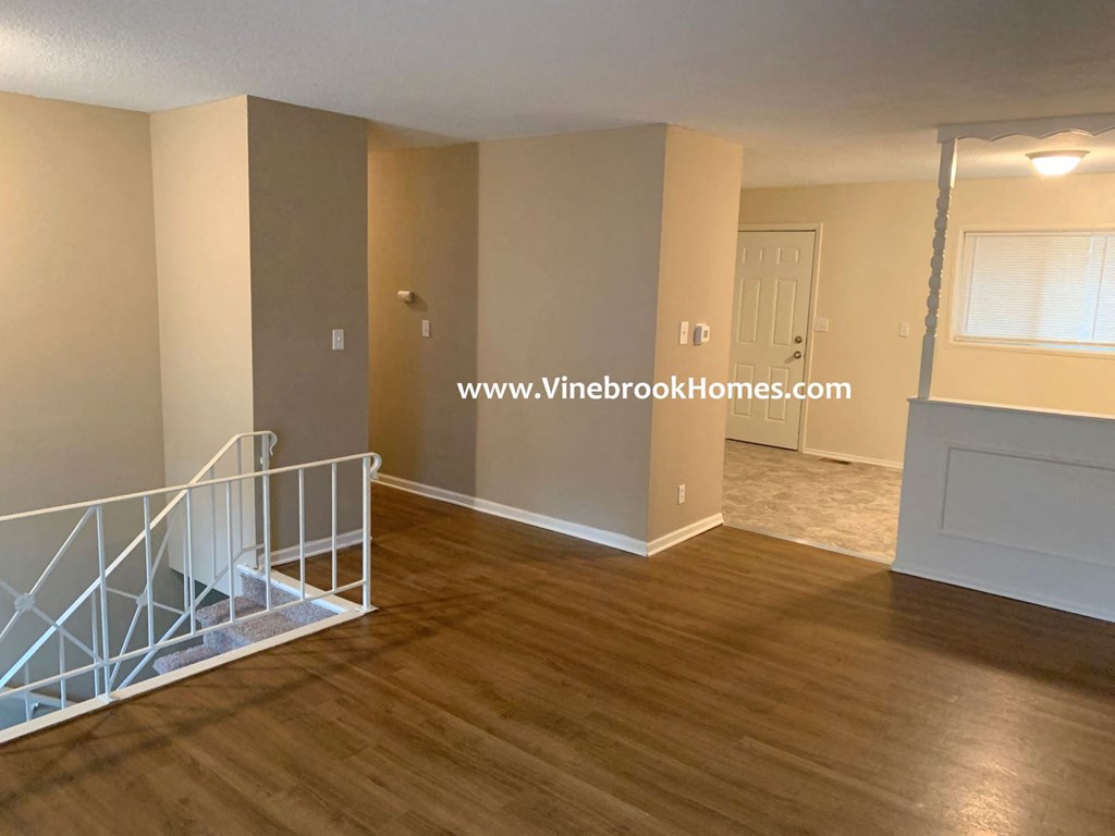 a view of the living room and dining room from the stairs