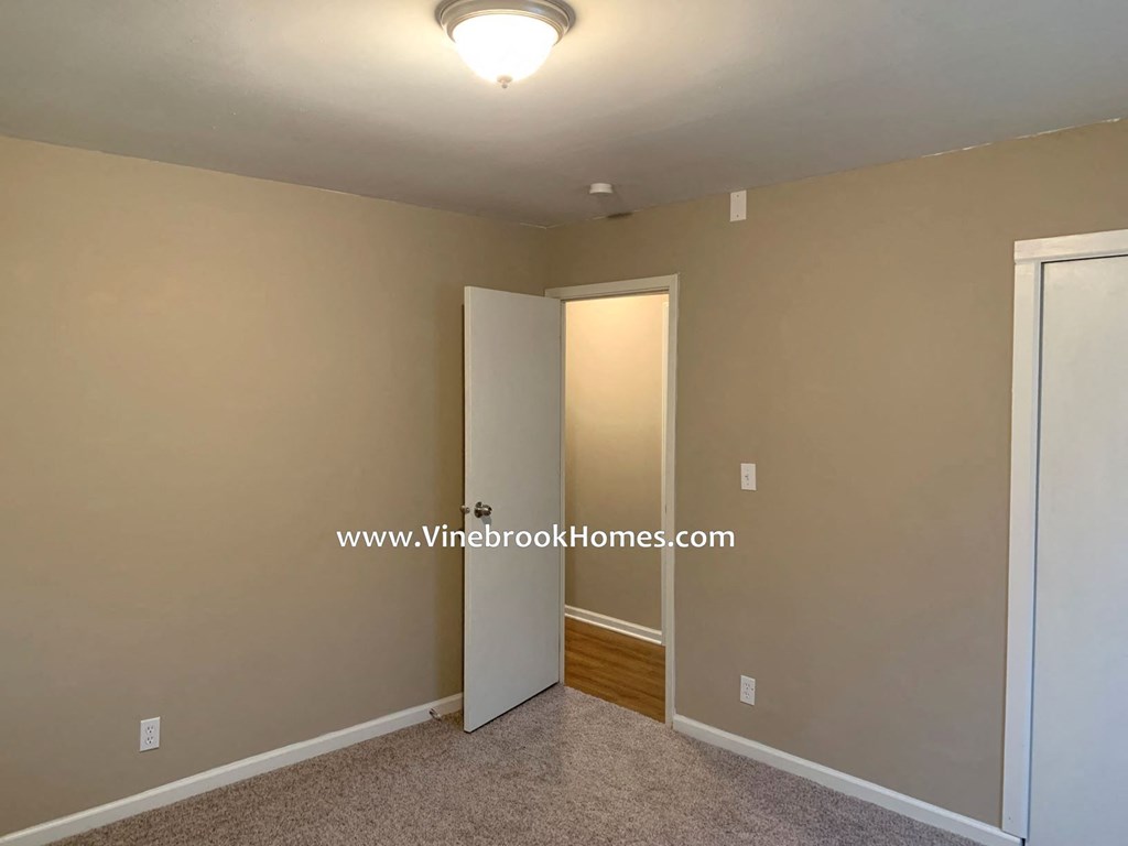 a bedroom with a closet and a door to a bathroom