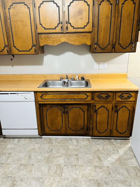 a small kitchen with a sink and cabinets