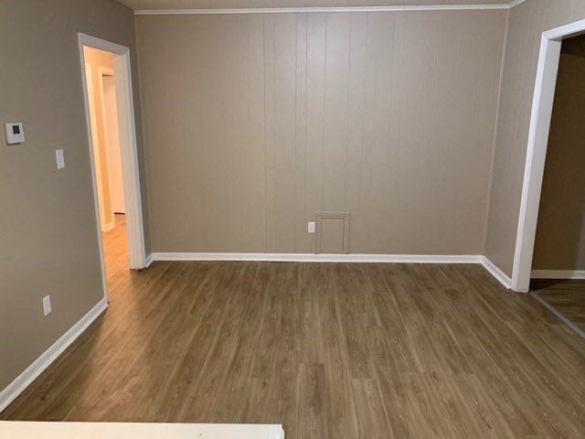 a empty living room with a wooden floor