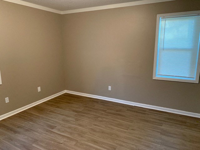 a empty room with wooden floors and a window
