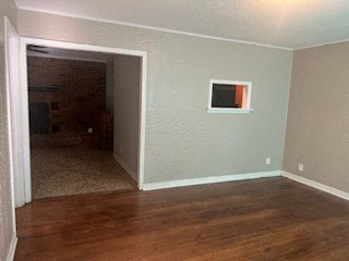 an empty living room with a hard wood floor