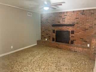 an empty living room with a brick fireplace