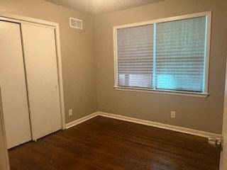 an empty room with a window and a door