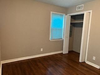 an empty room with a wood floor and a window