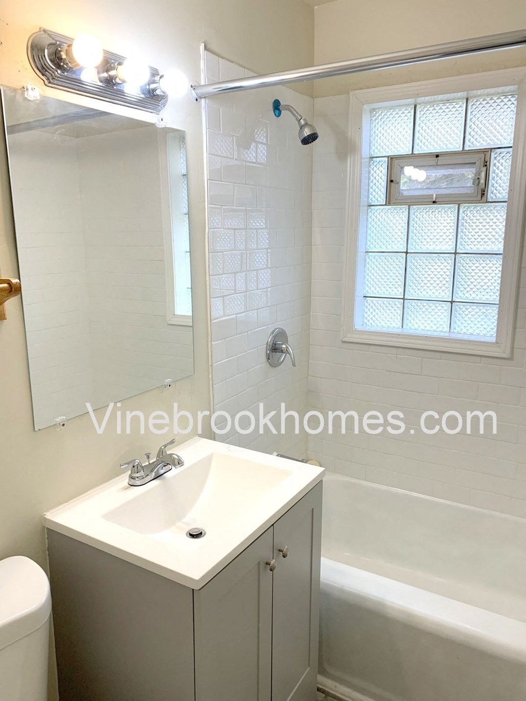 a small bathroom with a sink and a shower and a mirror