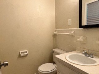 a bathroom with a sink toilet and a mirror