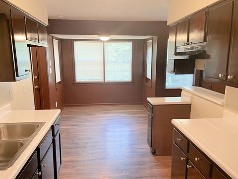 A kitchen with brown cabinets and a white countertop.