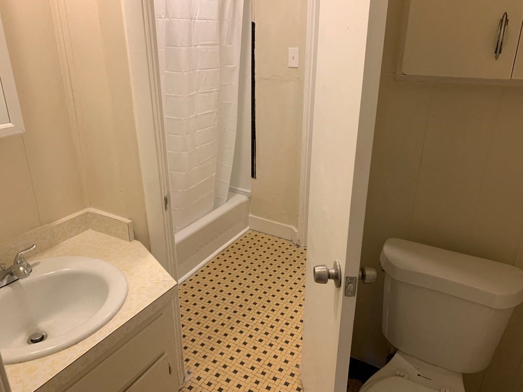 a bathroom with a sink toilet and a shower