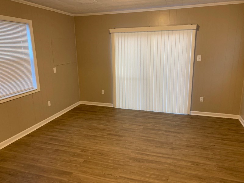 a living room with a wood floor and a sliding door