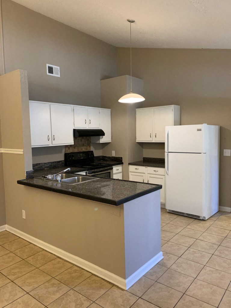 a kitchen with a counter top and a refrigerator
