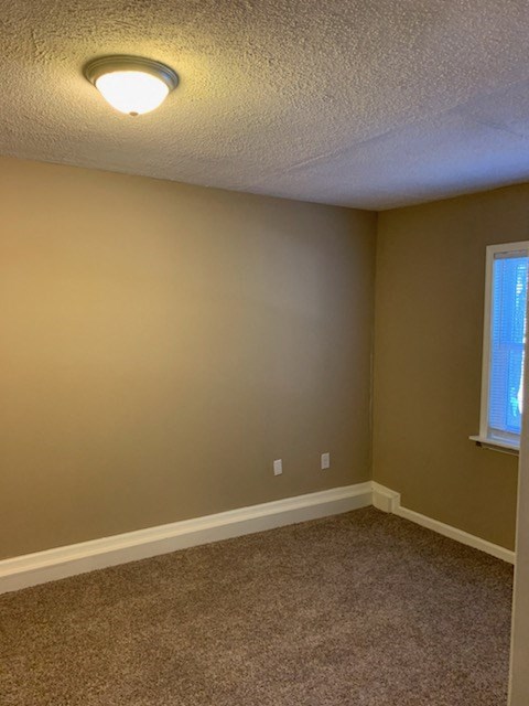 a empty room with a light on the ceiling