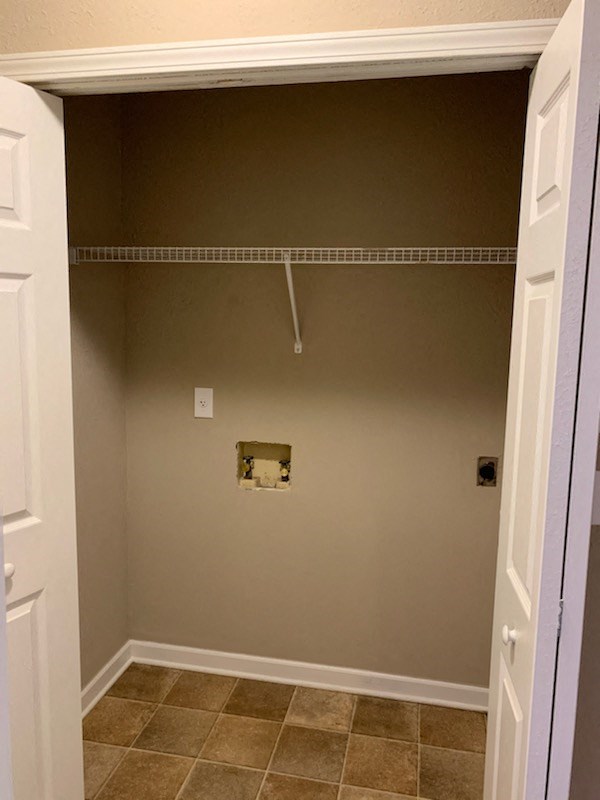a bathroom with a closet and a clothes rack