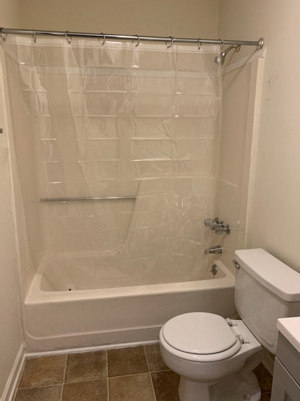 a bathroom with a toilet and a shower