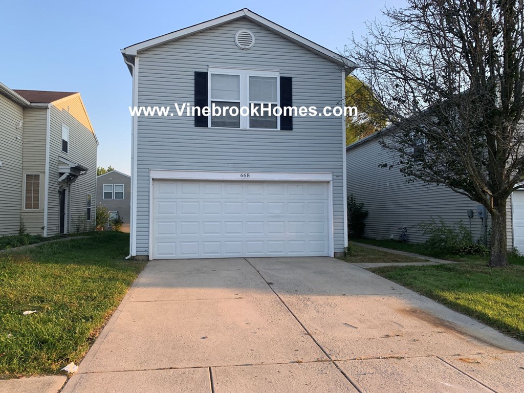 a white garage door in front of a house