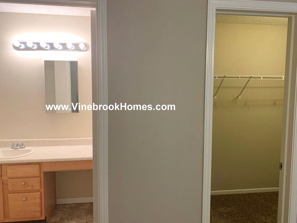 a bathroom with a shower and a sink and a mirror