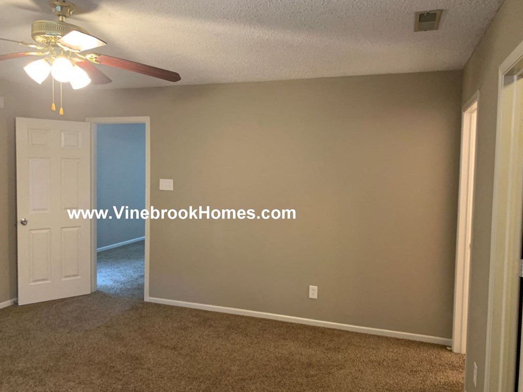 a bedroom with a closet and a ceiling fan