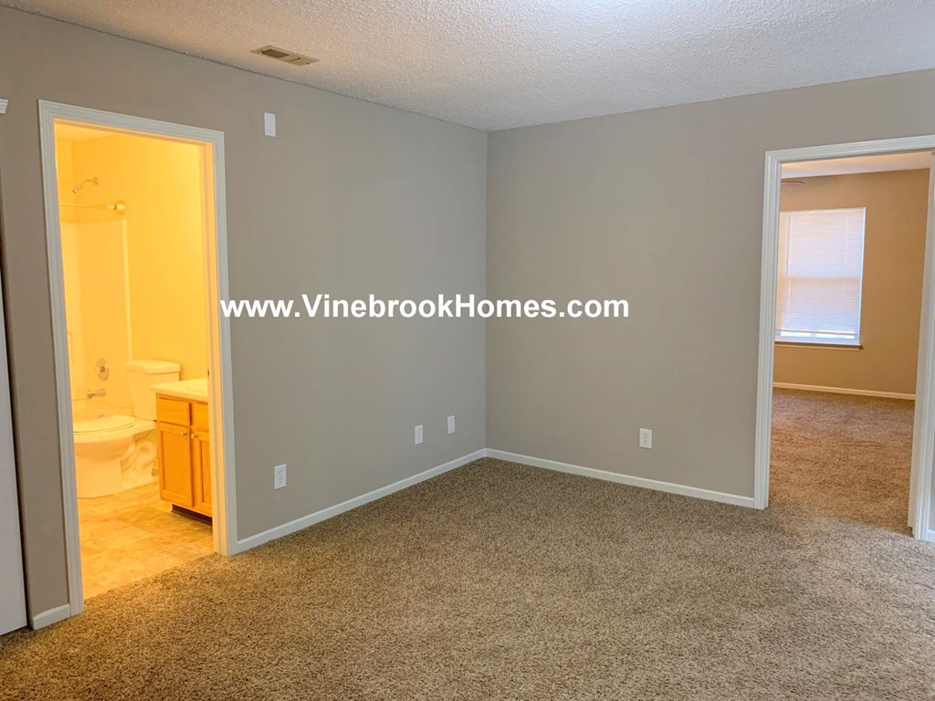 a bedroom with a bathroom and a closet