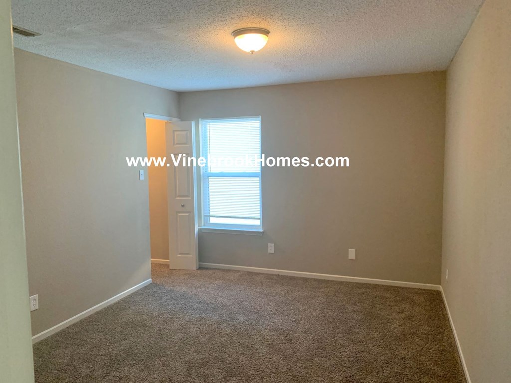 a bedroom with a closet and a window