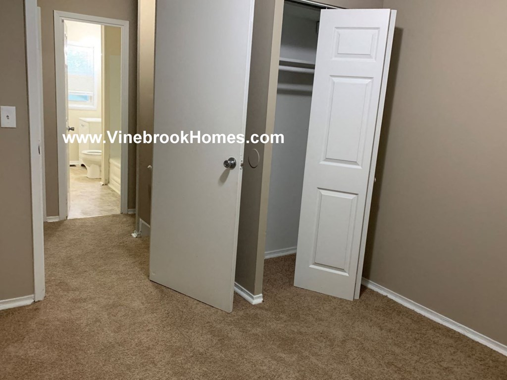 a closet in a small room with a white door
