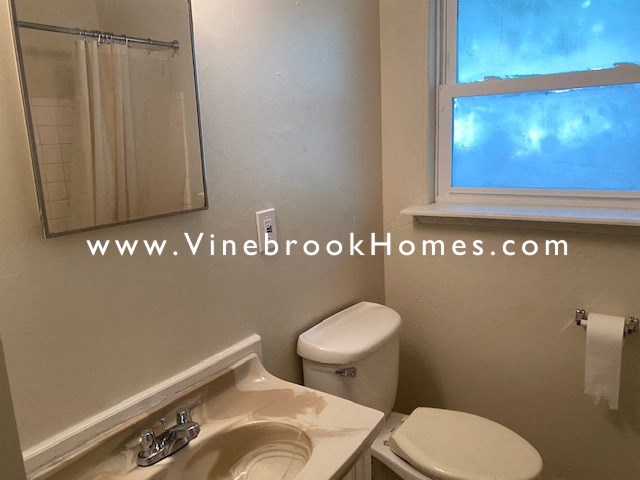 a bathroom with a toilet and a sink and a mirror