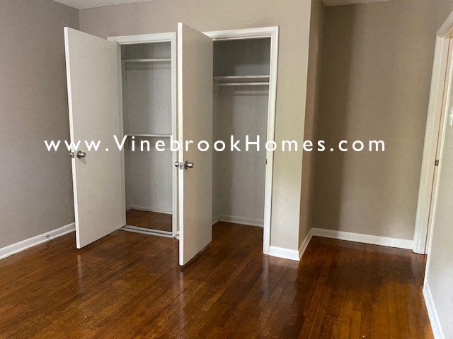 a closet in a living room with doors open