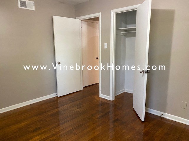 a bedroom with a closet and a door to a bathroom