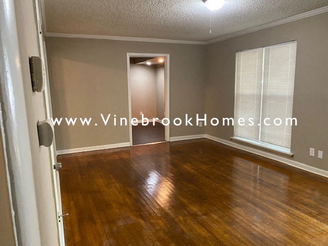 a living room with a hard wood floor and a window