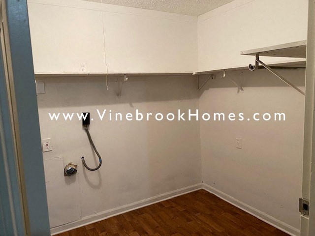a small bathroom with a shower and a shelf on the wall