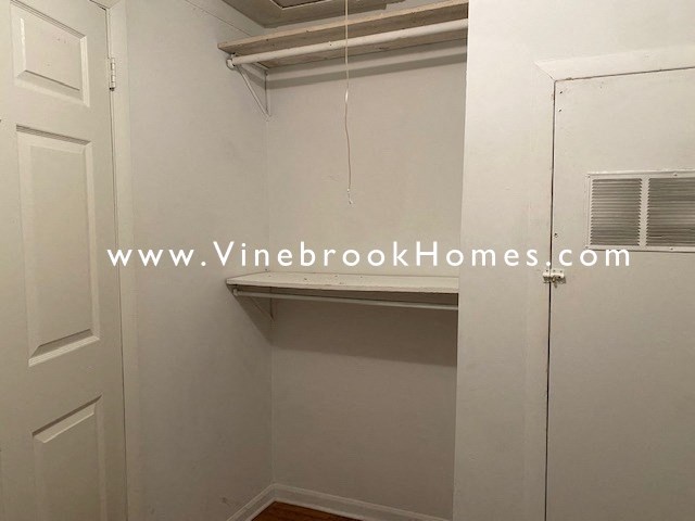 a closet in a small room with a white door