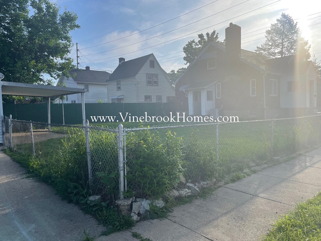 a chain link fence in front of a house