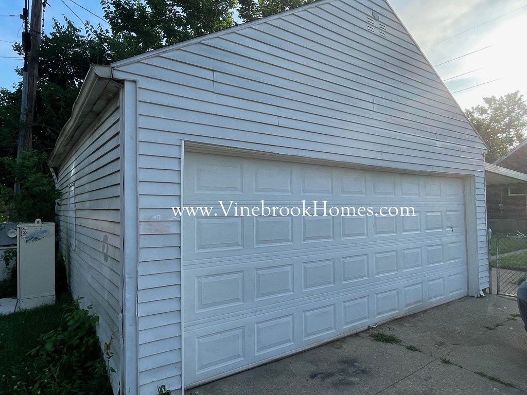 a small white garage with a white garage door