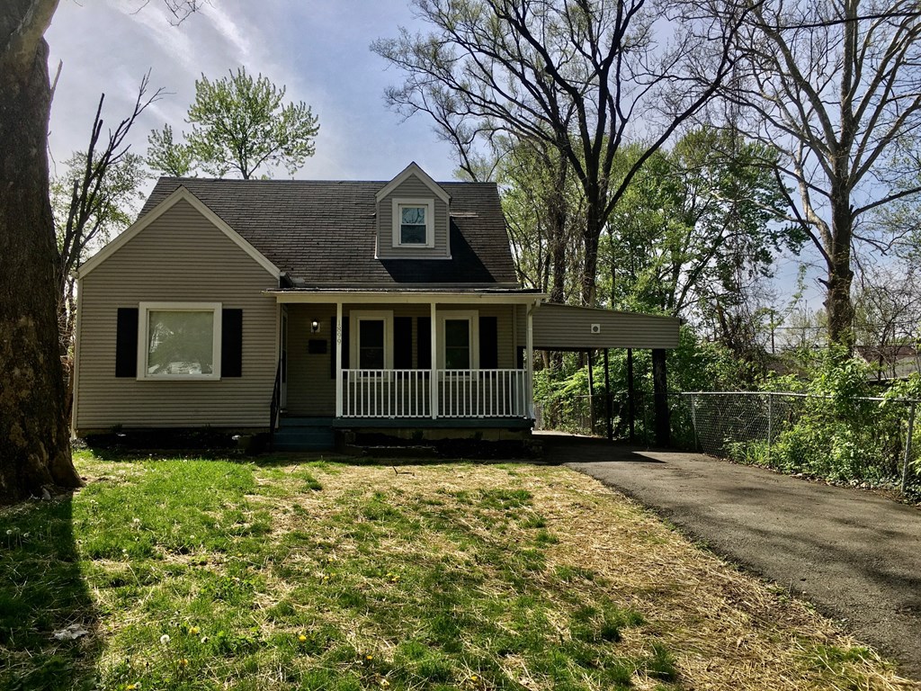 the front of a house with a yard and a driveway
